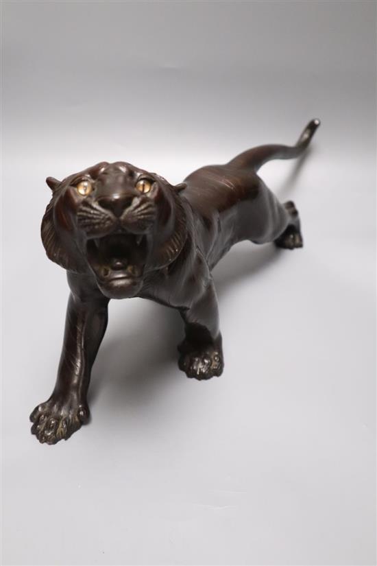 A Japanese Meiji bronze model of a tiger, signed, length 40cm